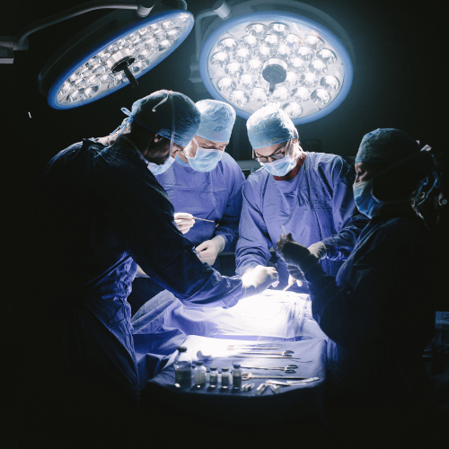 Plastic surgeons operating on a patient